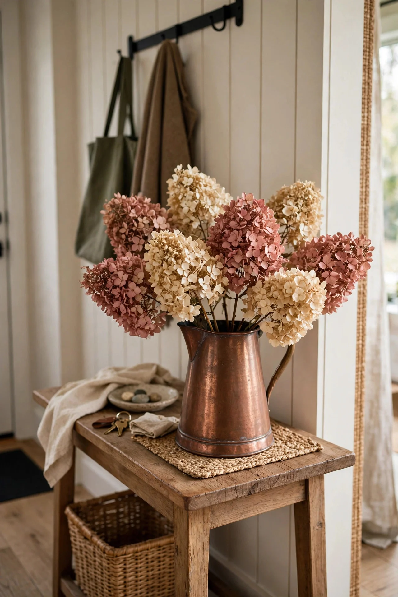 Dried hydrangeas in a copper pitcher